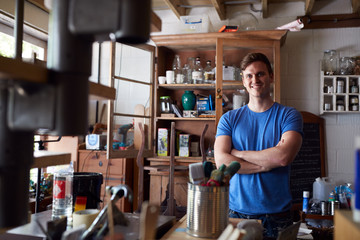 Portrait Of Confident Man Working In Workshop On Upcycling And Craft Projects