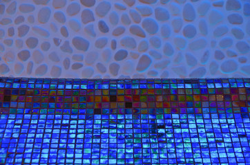 Heated loungers or day beds inside thermal suite relaxation room  with mood light in mosaic tiles...
