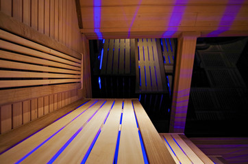 Finnish or dry sauna with oceanview or view of the sea inside male locker room of spa or wellness...