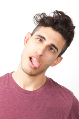 Fototapeta premium Portrait of young Middle Eastern man making funny faces over white background