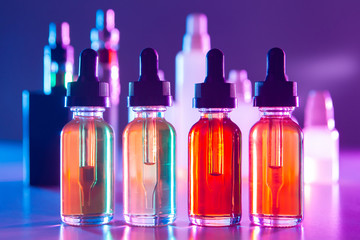 Vape liquids close-up. Juice bottles for the vaper. Oils for vaping on the background of electronic...