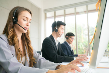 Telesale online marketing work on headphone and computer call to customer business men and women