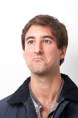 Obraz premium Thoughtful young man looking away against white background