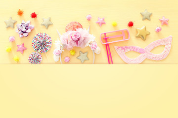 Purim celebration concept (jewish carnival holiday) over wooden table