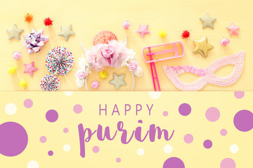 Purim celebration concept (jewish carnival holiday) over wooden table