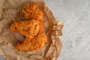crispy fried chicken on a brown paper.