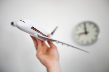 Close-up of hand holding model airplane