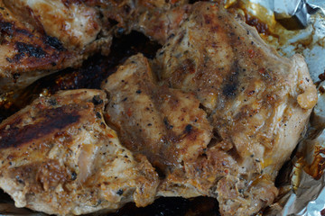 Close up on a grilled chicken over aluminium foil. Health concept