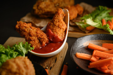 crispy fried chicken dipped in tomato sauce