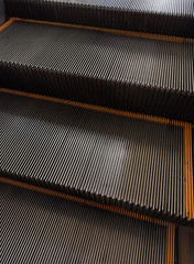 The image of the escalator surface is a grooved steel floor.