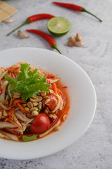Thai papaya salad in a white plate