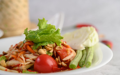 Thai papaya salad in a white plate