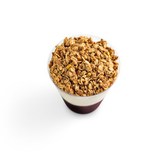 A refreshing smoothie with cream and granola on top. A delicious and healthy option for your breakfast or dessert.