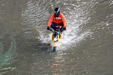 more floods and flooded motorcycle, motorcycle flood water on a road