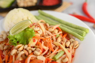 Thai papaya salad in a white plate