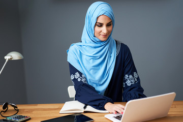 Muslim female student learning at home