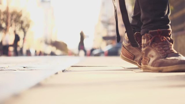 Unrecognizable men feets in sneakers is walking out. Urban Environment. Cropped. Blurred background. Action. Animation. 4K.