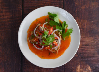 Sardines in tomato sauce and herb on white dish