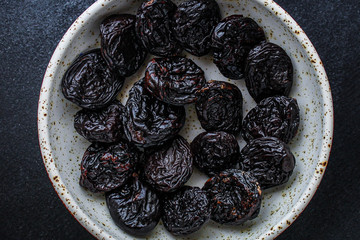 prunes, dried plums (tasty and healthy fruits) menu concept. background. top view. copy space