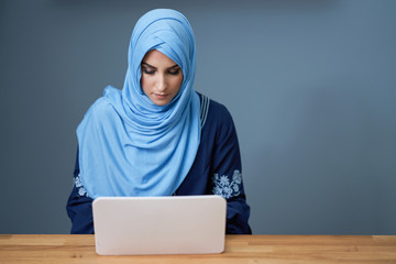 Muslim female student learning at home