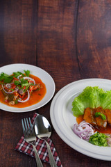 Spicy salad of sardine with tomato sauce in white dish