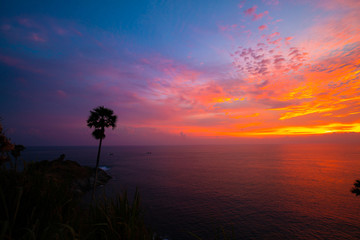 Naklejka na ściany i meble Colourful majestic sunset sky with cloud on sea shore wide angel len