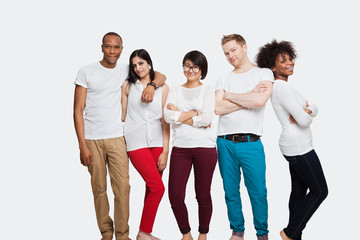 Obraz premium Portrait of multi-ethnic friends in casuals standing together over white background