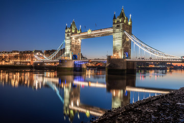 Tower Bridge with reflection in Thames river during twilight, London, UK