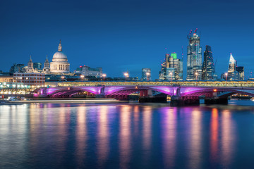 Fototapeta na wymiar St Pauls Cathedral from across the Thames with Backfriars bridge and London skyscraper during twilight in London, UK