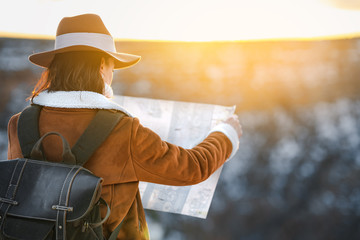 Young woman with a map in the Grand Canyon