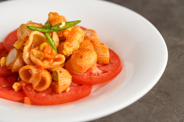 Stir fried macaroni with tomato sauce and pork