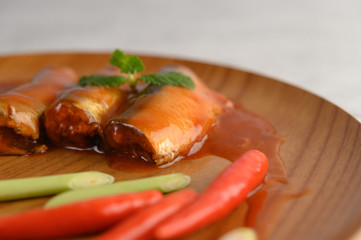 Appetizers salad of sardine in tomato sauce on wooden tray