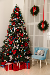 Beautiful Christmas tree decorated with toys and gift boxes