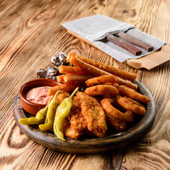 set of snacks with baked squid rings, chicken nuggets and bread sticks