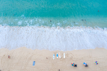 Fototapeta na wymiar aerial view landscape ocean wave foam on the sand beach and travel tourists