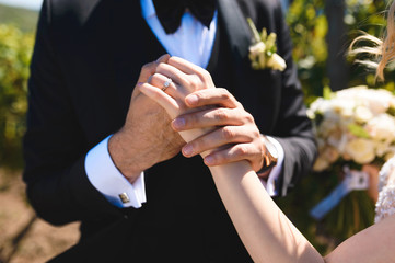 groom holding hand of bride