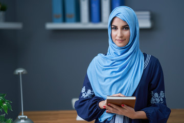 Muslim female student learning at home