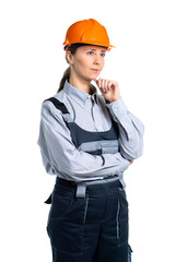 pretty cute builder girl in uniform and helmet . Isolated