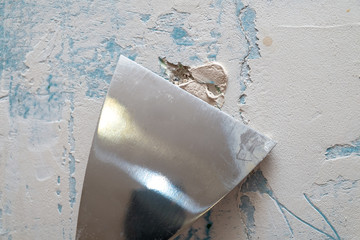 Metal spatula closeup. The plaster is laid on the wall with a spatula.