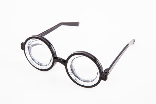 Close-up of thick glasses over white background