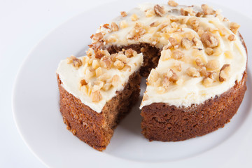 Walnut cake in plate over white background