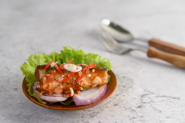 Appetizing Spicy Canned Sardine salad with spicy sauce in wood bowl