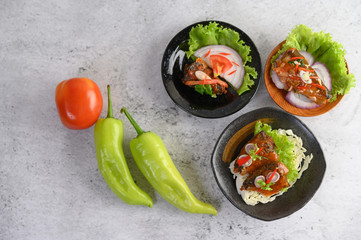 Appetizing Spicy Canned Sardine in spicy sauce in black ceramic bowl
