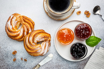 Fresh and bright continental breakfast table with buns with cottage cheese, coffee and jam, top view