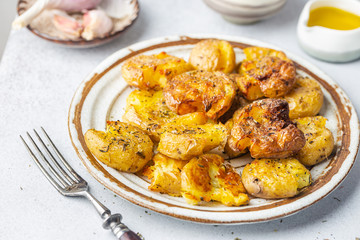 Homemade baked smashed baby potatoes with garlic, salt and herbs