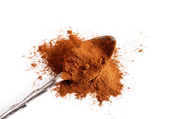 Cinnamon powder and cinnamon sticks on a light background