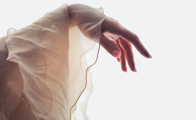 Delicate female hand and silk fabric. Hand Care Symbol