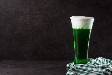 Traditional St Patrick's Day green beer on black background. Copy space 