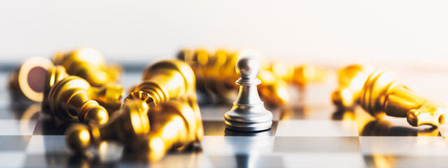 King lying down and pawns standing. Business leader concept for market target strategy on white background with free copy space for text. Competition and winners in doing business. King of chess.