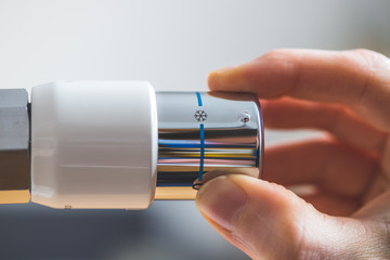 Heating costs: Heat regulator on a heater, close up picture. Set on off.